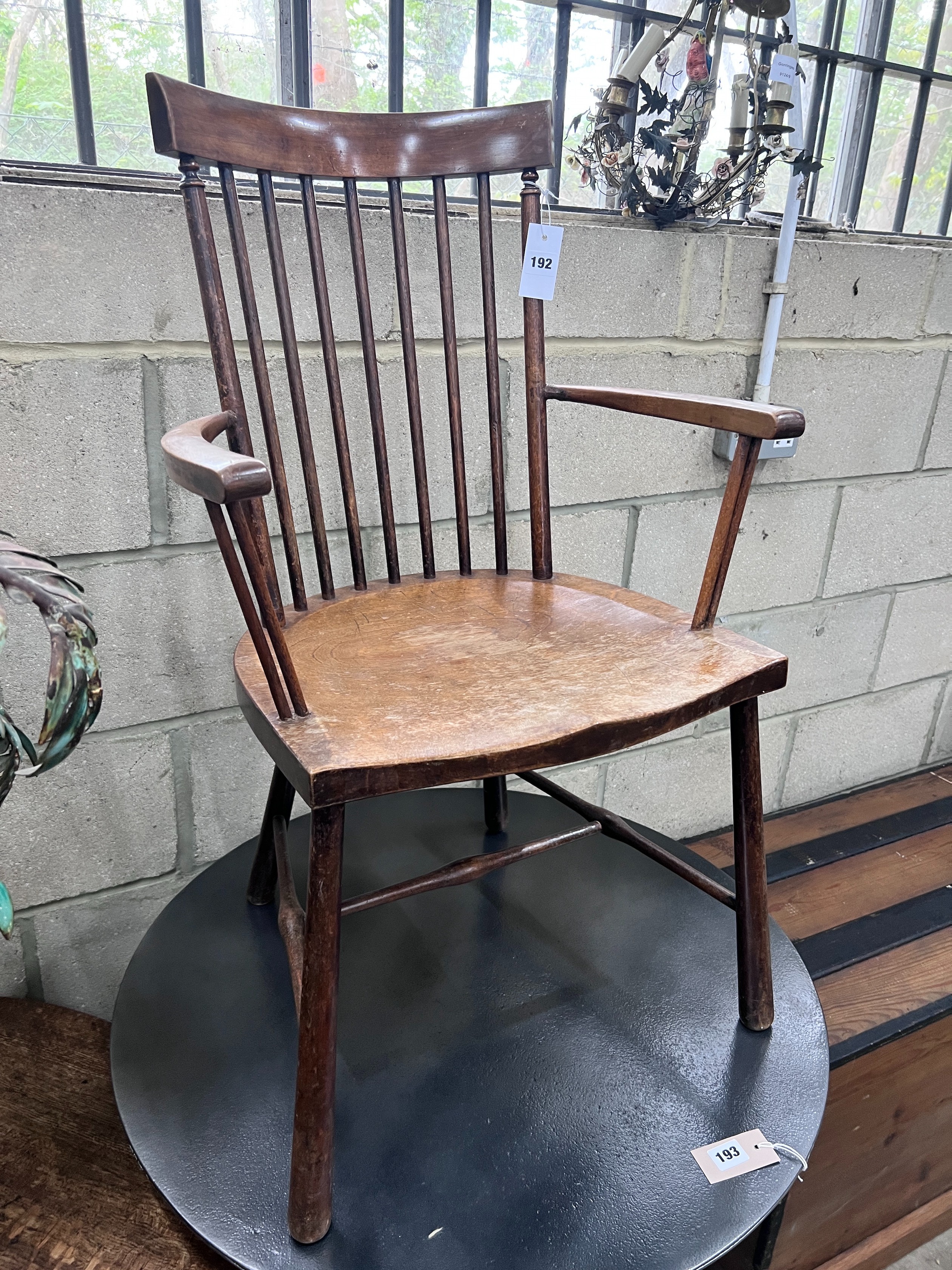 An Arts & Crafts beech Windsor comb back elbow chair, width 49cm, depth 41cm, height 86cm *Please note the sale commences at 9am.